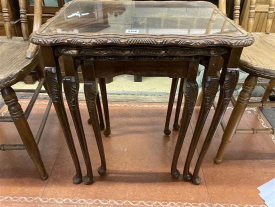 A nest of three walnut tea tables and a pair of early 20th century ash comb back dining chairs
